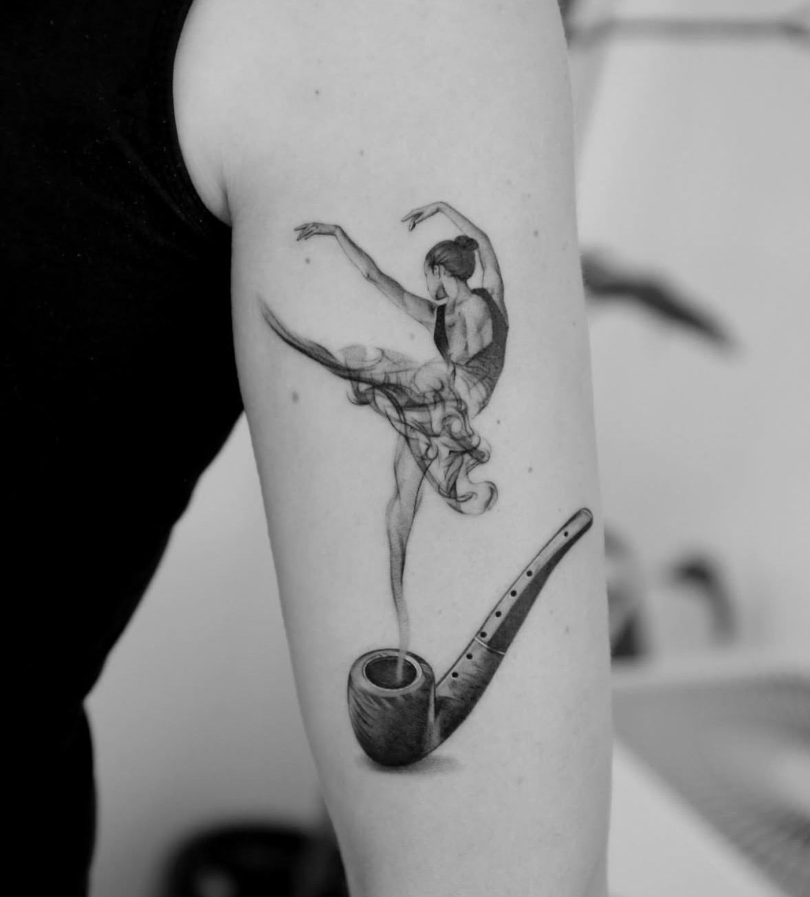 Smoke rising from a pipe and forming a ballerina.