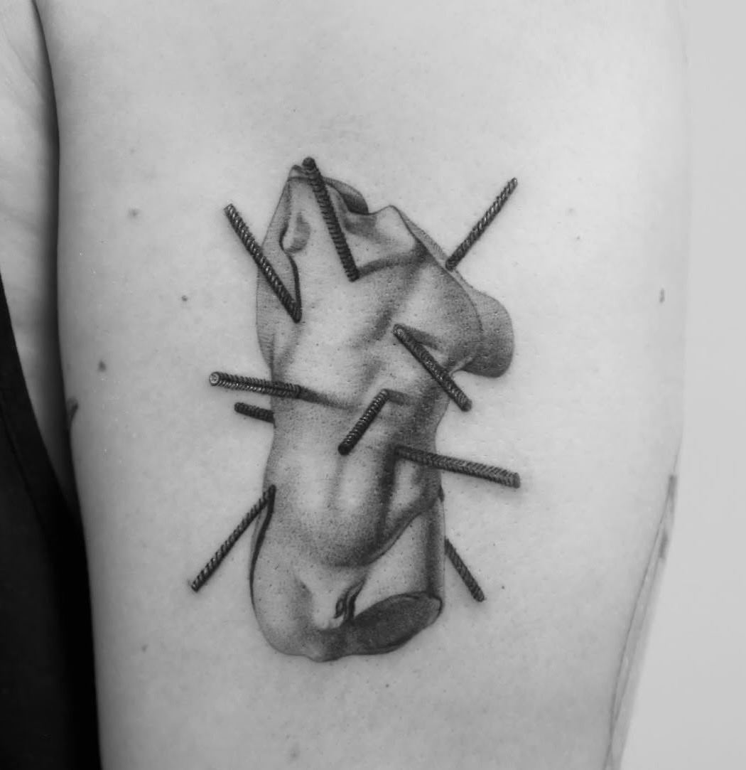 A classical torso pierced by steel rebar rods.